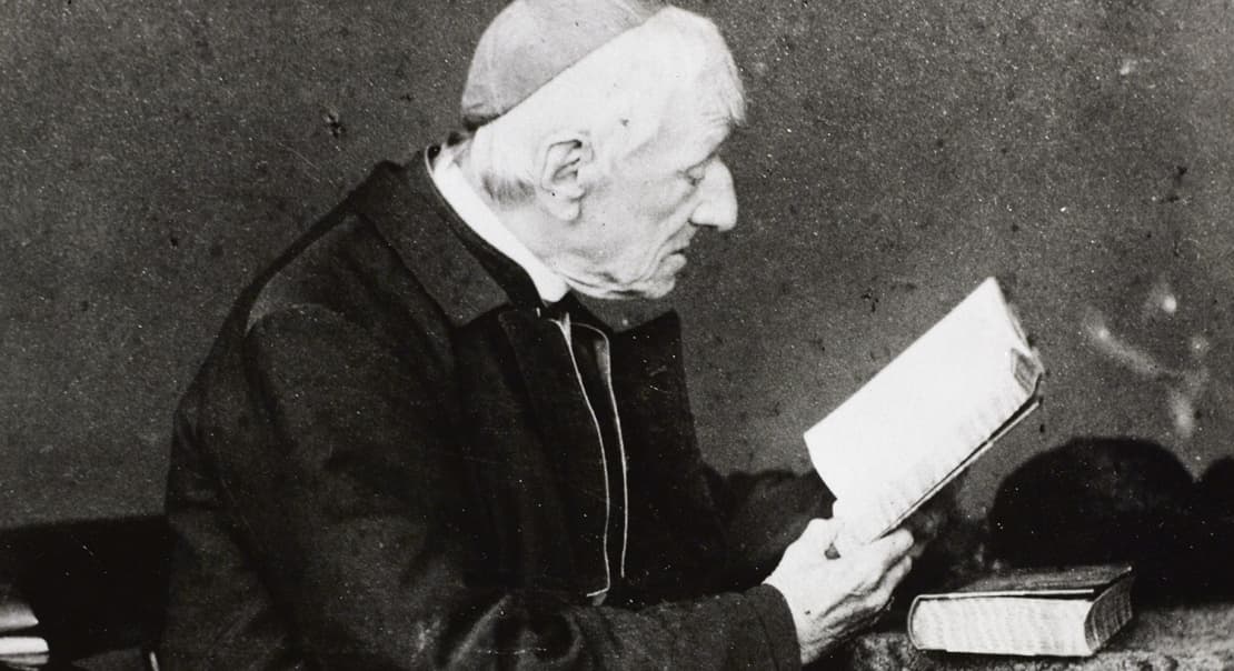 St. John Henry Newman reading at his desk